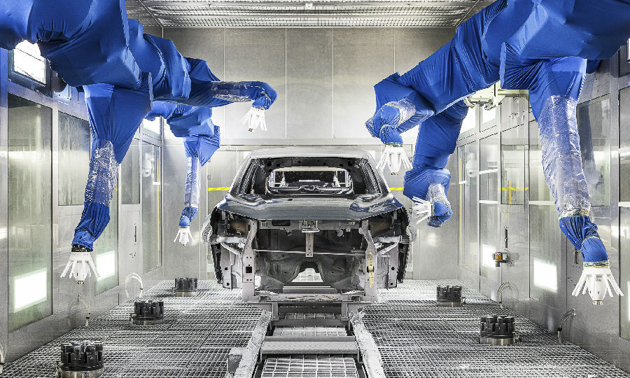 圖為長安汽車合肥工廠的機器人正在進行清漆工藝。