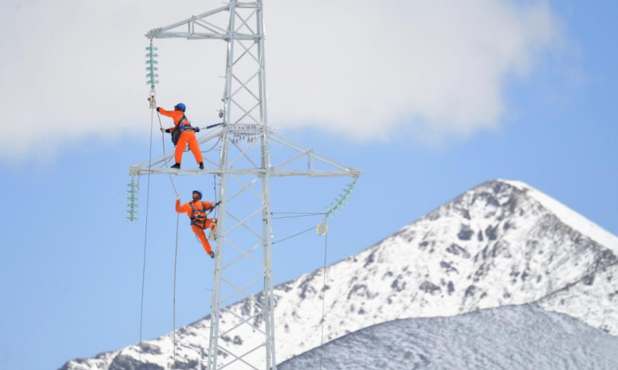 5月16日下午4時許，氣溫低至零攝氏度，在海拔4600米的理塘—下壩35千伏線路工程施工現場，電力建設者正攀附在鐵塔上加緊施工，天空卻突降大雪，風刀霜劍。