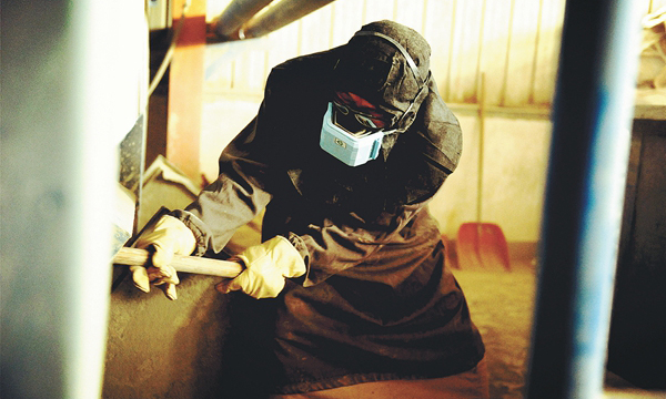 4月30日，中海油能源發展股份有限公司物流公司龍口基地輸灰站輸灰工正在進行掏灰作業。輸灰作業是保障海上平臺正常生產的重要環節。輸灰作業時，為了保證安全生產，輸灰工需要全副武裝作業，隨著氣溫的升高，每次作業完，他們的工服和工鞋就全被汗水浸透了，臉上也布滿了汗水，伴隨著粉塵流下。