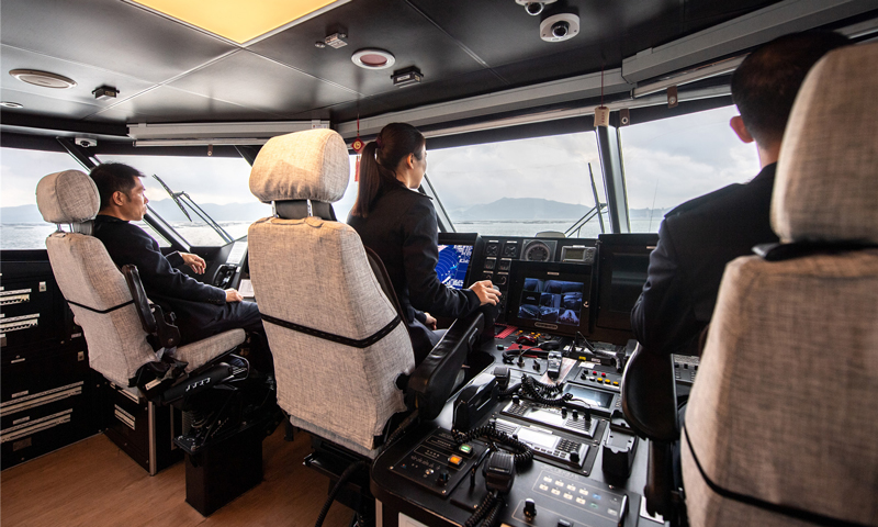 由于船體結構特殊性，風浪較大時，船舶產生的瞬時橫搖角度達到二十多度，對于駕駛員身體素質有很高的要求。遇到濃霧或暴雨導致能見度不高，只能根據雷達屏幕顯示的海面情況操縱船舶，駕駛員的心理素質也面臨著極大考驗。何倩倩從小與海結緣，堅韌樂觀。她總是迎難而上，以良好的心理素質、熟練的駕駛技巧、敬業的工作態度將旅客安全送達。圖為迅隆7號高速客船駕駛艙。（唐蜀全 攝）