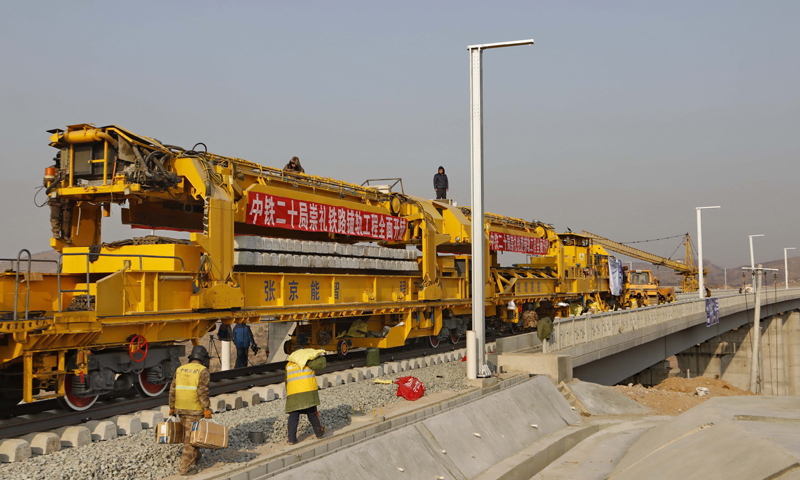 崇禮鐵路位于河北省張家口境內，全長53公里，線路自京張高鐵下花園北站引出，終點至崇禮區太子城站，設計時速每小時250公里。圖為1月6日，工人在崇禮鐵路張家口市下花園區戴家營大橋鋪軌現場工作。（新華社記者 楊世堯 攝）