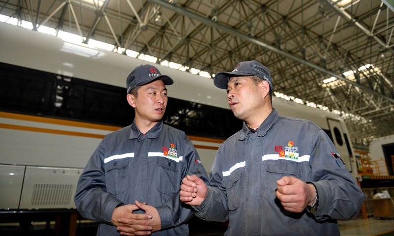 49歲的周晶輝是中車長客股份有限公司首席操作師，也是中車長客“國家級技能大師工作室”負責人。從1989年進廠至今，他總結優秀操作法二十余項、立項攻關十余次，獲國家專利兩項，對新一代高速動車組，特別是對“復興號”動車組生產作出了突出貢獻。圖為4月27日，周晶輝（右）與徒弟臧鐵軍研究高鐵車體改進工藝。（新華社記者 張楠 攝）