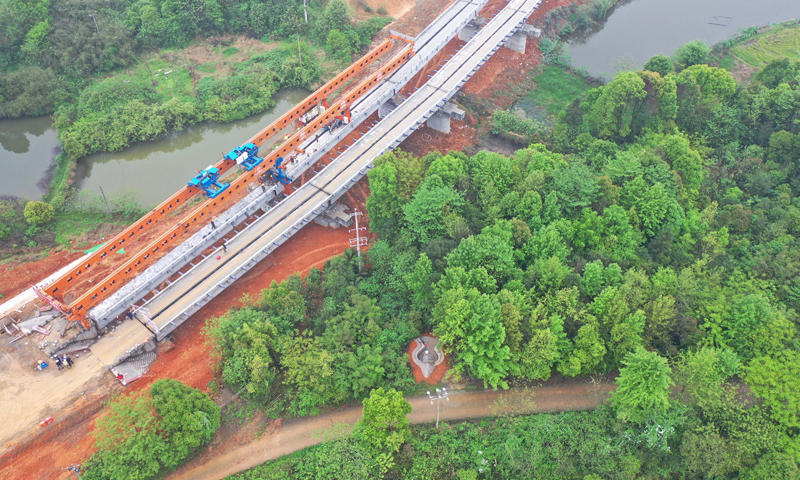 常益長鐵路全長157公里，設計時速350公里，是國家“八縱八橫”高速鐵路網的重要組成部分。圖為4月5日拍攝的常益長鐵路6標動走左線特大橋T梁架設現場。（新華社記者 趙眾志 攝）