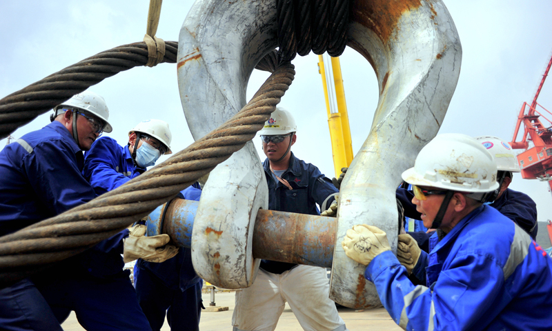 近日，海洋石油工程股份有限公司建造事業部浮體作業平臺生產作業現場異常繁忙。加拿大LNG核心工藝模塊第10船36臺大中型設備到貨，員工郭光海帶領施工人員奮力進行大型吊裝索具的掛扣工作。