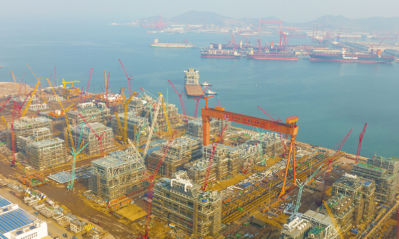 據加拿大LNG項目經理莊宏昌介紹，本次裝船的模塊由三層主甲板組成，高度超過13層樓，重量相當于近4000輛小汽車，對裝船技術方案設計、SPMT（自行模塊化運輸車）操作及指揮能力均提出很高要求。圖為海油工程加拿大LNG項目首個核心工藝模塊緩緩駛離青島場地碼頭。