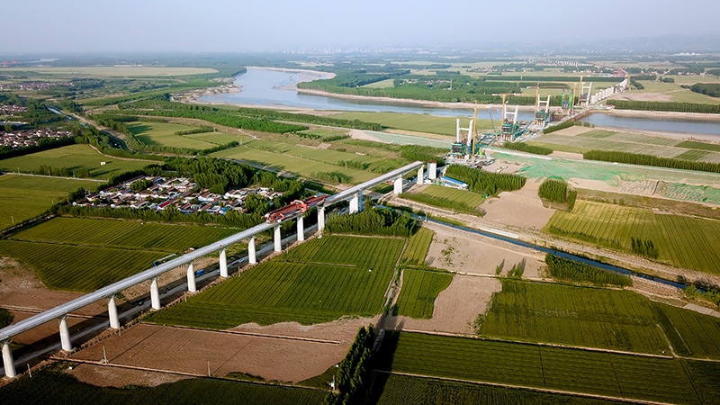 5月21日，中鐵上海局工作人員在濟鄭高鐵山東長清黃河特大橋施工現場架設箱梁（無人機照片）。新華社記者 郭緒雷 攝