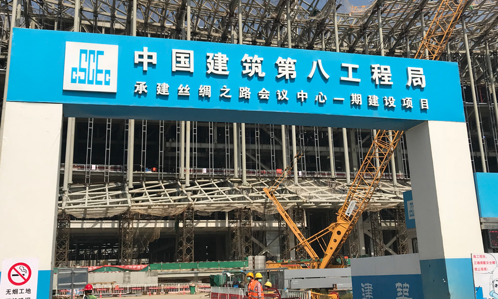 西安絲路國際會議中心工程項目幕墻高度58.80米，幕墻面積約20萬平方米，分為FS1大跨度組合鋼吊柱玻璃幕墻、FS2底層坐式全玻幕墻、FS3上下月牙金屬幕墻（基層為直立鎖邊屋面），幕墻造型復雜，且成弧線布置。圖為項目施工現場。（王文鐸 攝）